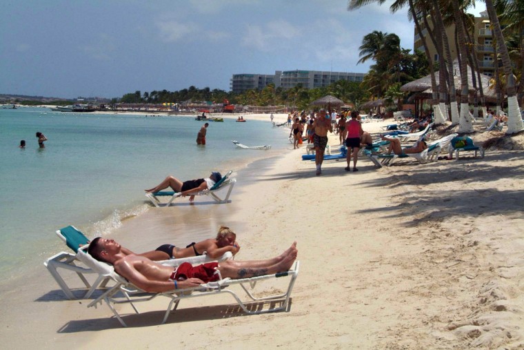 Tourists relax on the beach in Oranjestad, Aruba. Acording to NOAA figures, Aruba has only a 2 percent chance of being hit by a hurricane.