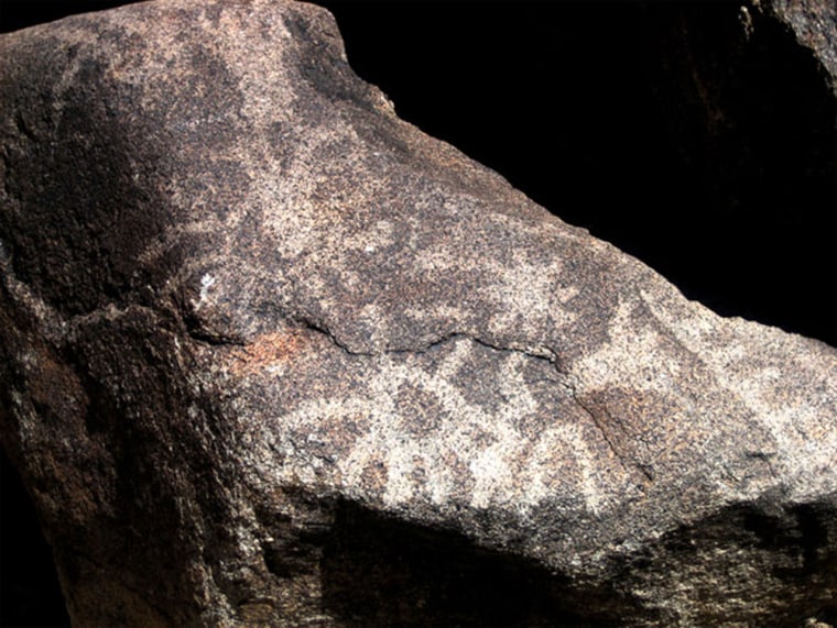 A petroglyph possibly depicting the supernova of A.D. 1006 (star symbol, right of center) and the constellation Scorpius (scorpion symbol, left of center). The boulder on which the petroglyphs appear is located in White Tanks Regional Park in Phoenix.