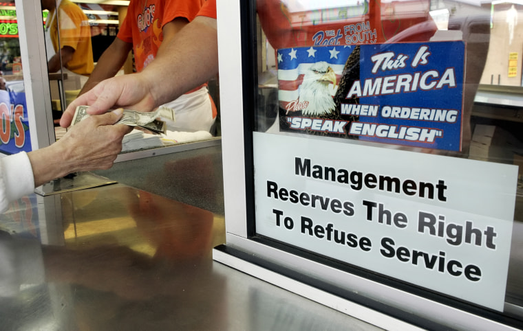 A sign telling customers they must order in English graces the counter Wednesday at Geno's Steaks in Philadelphia. 