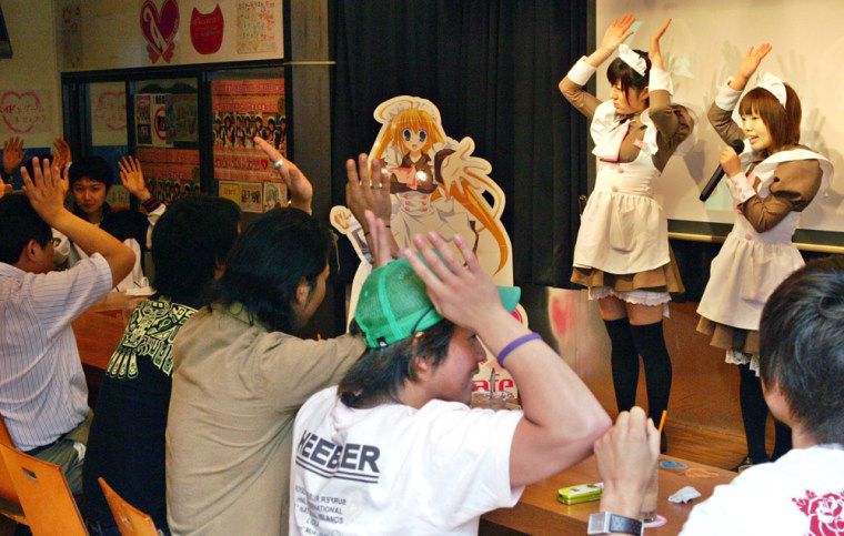 Customers at a Tokyo 'maid cafe' play a game with costumed employees. Customers drop as much as 10,000 yen ($90) a visit for a chance to gawk at the girls, who all vow they are 'eternally 17 years old.'