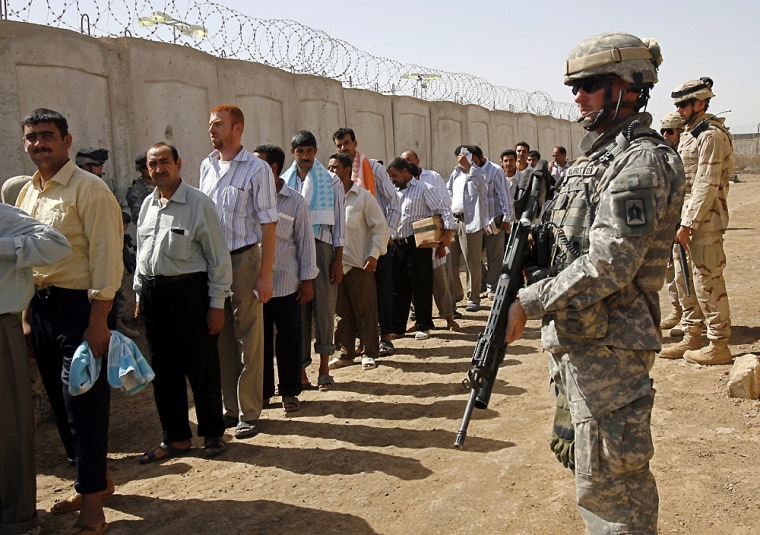 U.S. soldiers stand guard at Abu Ghraib prison shortly before 200 prisoners were freed under a national reconciliation plan announced by Prime Minister Nouri al-Maliki last week. Iraqi officials are asking the U.S. to delay its handover of the prisons due to concerns about militia infiltration.