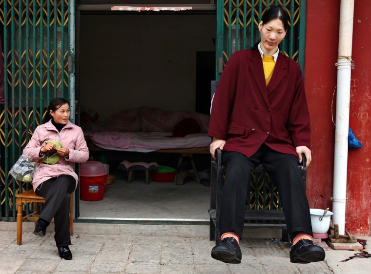 Tallest woman in Asia and her friend sit in Shu Cha in eastern China's Anhui province