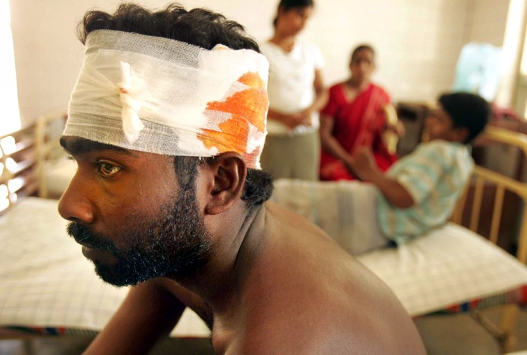 Victims of a cross-fire between Sri Lankan government soldiers and Tamil rebels recover at a government hospital in Mannar on Saturday.
