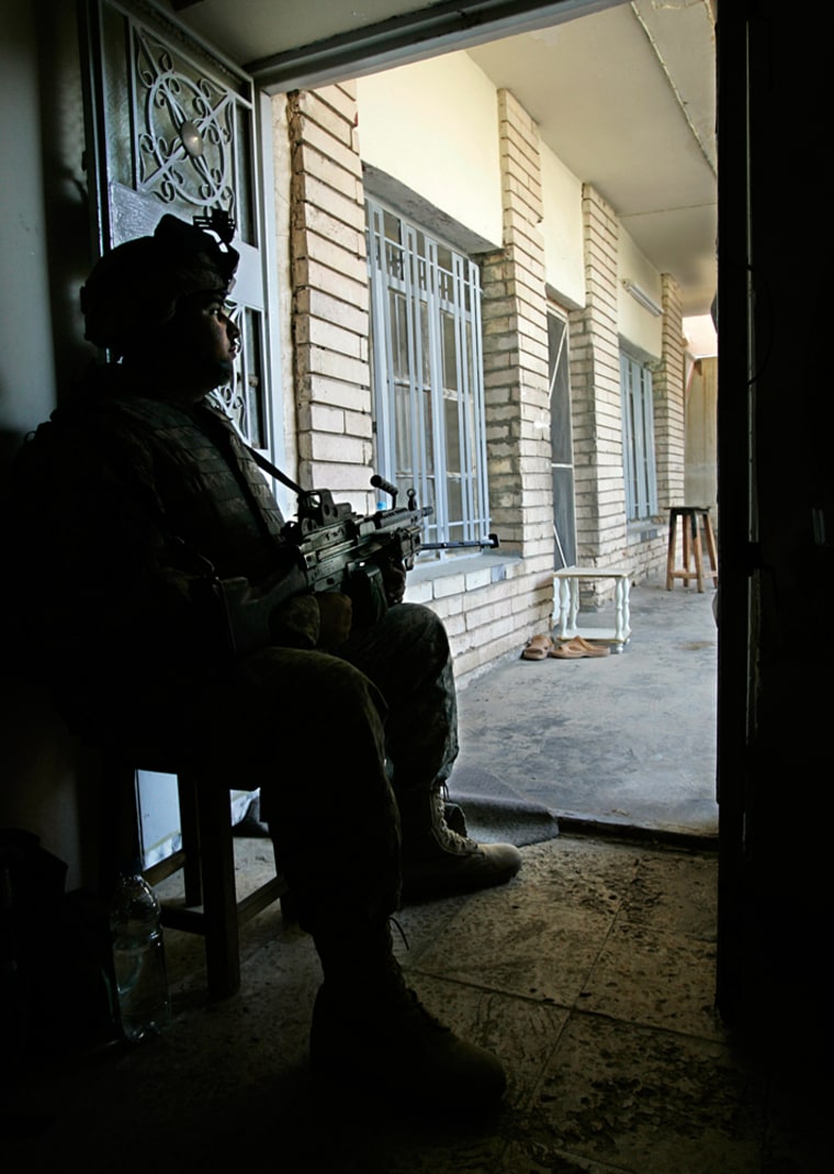 U.S. Army Spc. Saul Rosa, of Hinesville, Ga., sits guard at a house in Ramadi on Monday. Hundreds of U.S. and Iraqi troops pushed into an eastern section of the city to rid the area of insurgents.