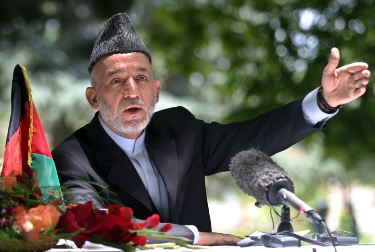Afghan President Karzai gestures during news conference in Kabul