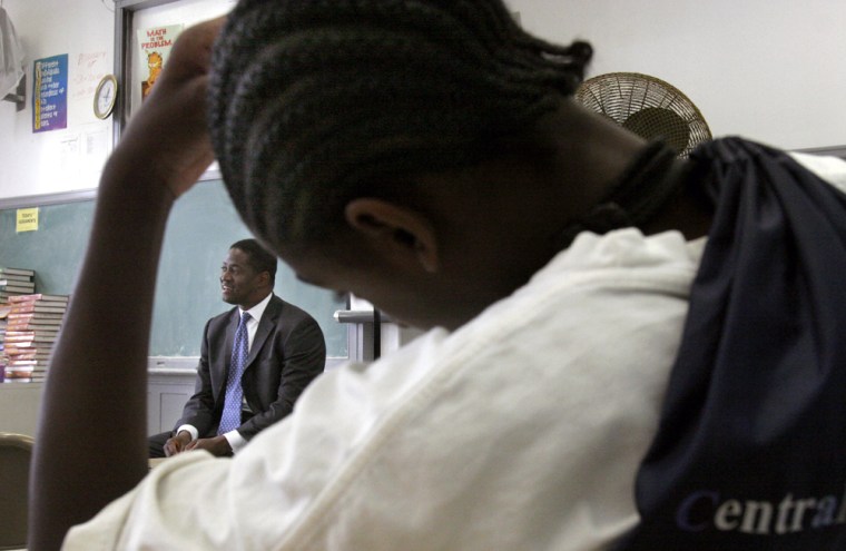 ** ADVANCE FOR SUNDAY, JULY 2 **Karrym Ferguson, a 10th grader at Central High School in Newark, N.J., listens to Mark Ferguson, left, during his visit to the school, June 13, 2006. Ferguson, a Wall Street financier who grew up in Newark and attended the same school, established \"A Day In The Life Foundation\" to help students succeed.  (AP Photo/Bebeto Matthews)