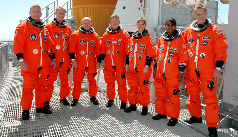 Space shuttle Discovery crew poses atop Launch Pad 39B at the Kennedy Space Center in Cape Canaveral