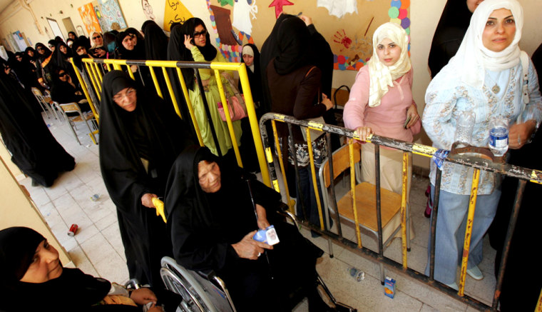 Kuwaiti women wait for their turn to vote at polling station in Kuwait City