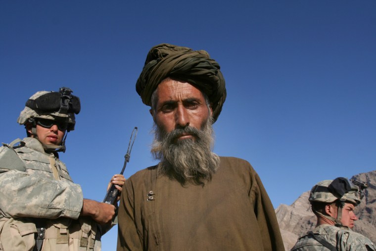 Lt. Will Felder, left, after talking with a villager in the southern province of Helmand, on June 21. The soldiers were on a mission in support of Operation Mountain Thrust, an offensive to root out Taliban militants in southern Afghanistan. From generals to ground-level lieutenants, the U.S. military here has the same plan for success: Extend the reach of the Afghan government. 