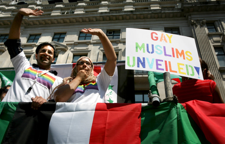 Members of the British gay, lesbian, bisexual, and transgender Muslim group Imaan wave from atop a float during the EuroPride 06 parade in London, England, on Saturday.