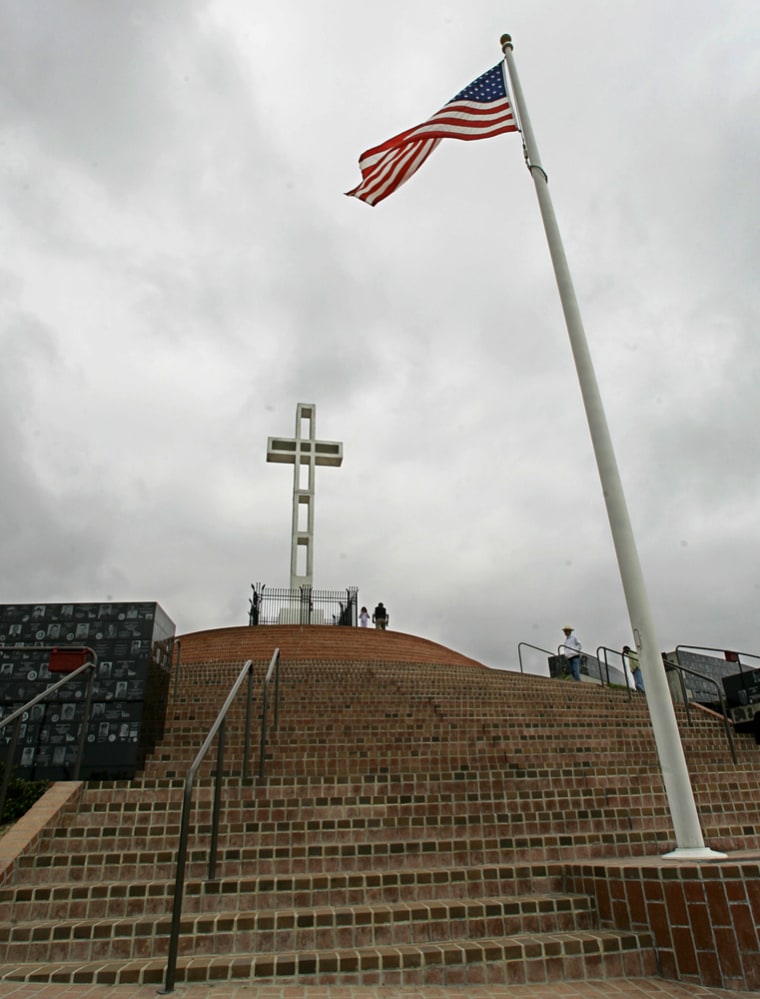 Visitors walk around the 29-foot Mount Soledad Cross at the Mount Soledad Veterans Memorial in San Diego in this May 3 file photo.