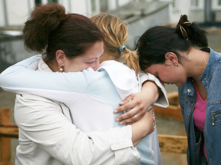 Relatives of a Airbus-310 crash victim comfort each other at the airport of Russia's Siberian city of Irkutsk