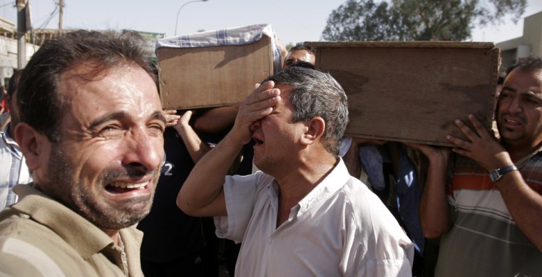 Iraqis on Monday mourn the loss of relatives killed in a car bomb attack in Baghdad, Iraq. 
