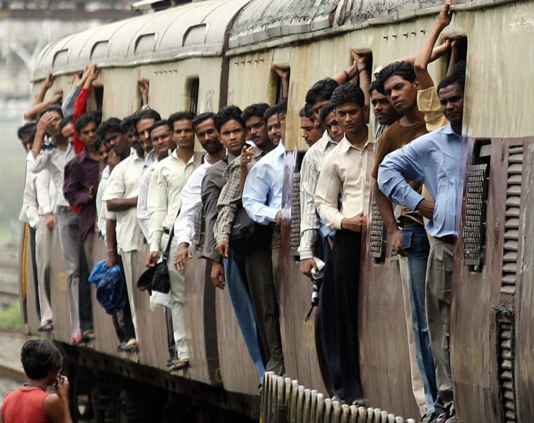 Commuters travel on train in Mumbai