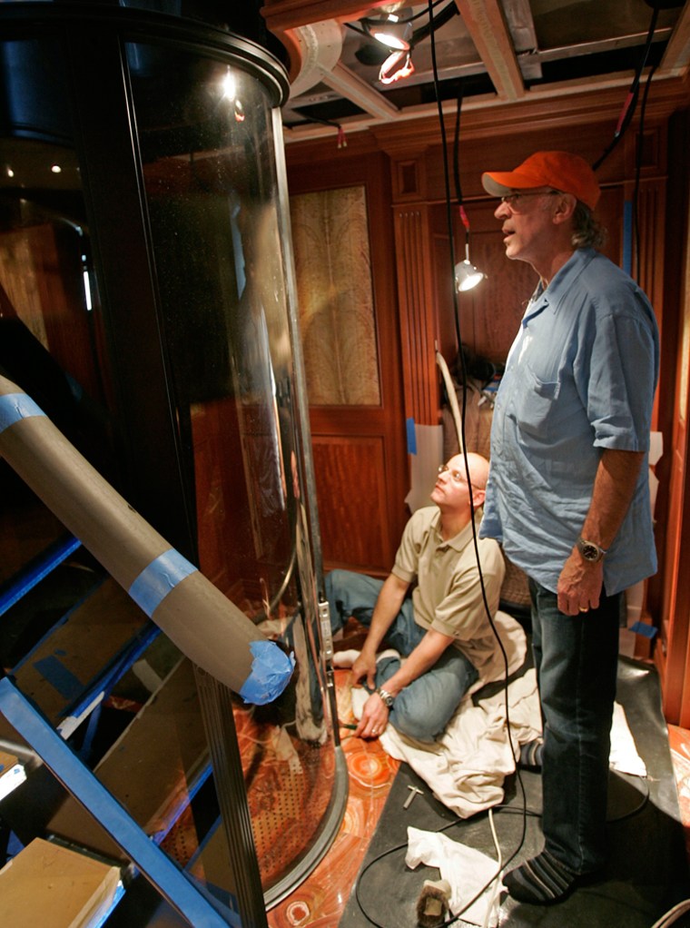 Burger Boat President and CEO David Ross, right, watches as Ron Beilman works on an elevator in one of the large yachts the company is building, Friday, May 26, 2006, in Manitowoc, Wis. For Burger Boat, the average boat size has stretched to 147 feet from 104 feet in 2003. Now business is booming at the 143-year-old company's shipyard, about an hour north of Milwaukee. (AP Photo/Morry Gash)