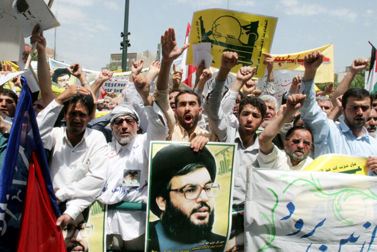 Demonstrators show support for Hezbollah with posters of leader Sheik Hassan Nasrallah during an anti-Israeli rally in Tehran, Iran, on Tuesday. Speaking to the crowd, Iranian parliament speaker Gholam Ali Haddad Adel told Israelis: "The towns you have built in northern Palestine (Israel) are within the range of the brave Lebanese children." 