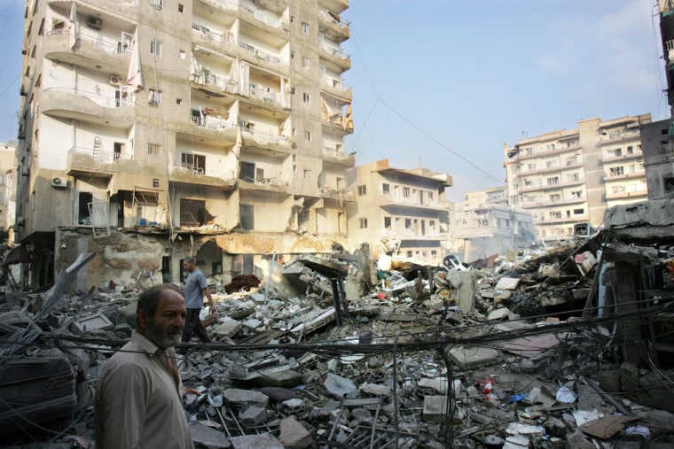 Lebanese people sift through the rubble