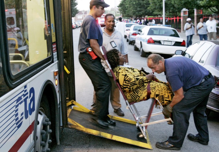 An unidentified woman is placed on a Chicago Transit Authority bus after being evacuated from her South Side high-rise apartment in Chicago, Tuesday, Aug. 1, 2006. About 20,000 people lost electricity in an outage that began Monday evening. Temperatures are forecast to climb into the 90s for the fifth straight day. (AP Photo/Charles Rex Arbogast)