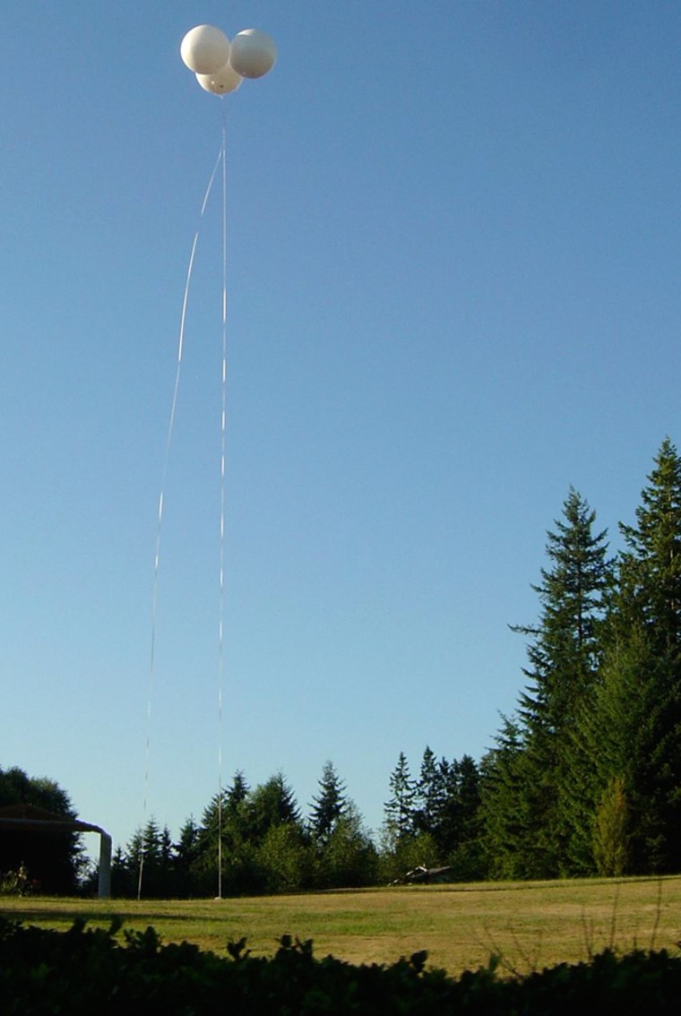 A three-balloon cluster rises above a rural area near Poulsbo, Wash., as part of LiftPort Group's test of a system that could provide wireless data services to remote or disaster-struck areas.