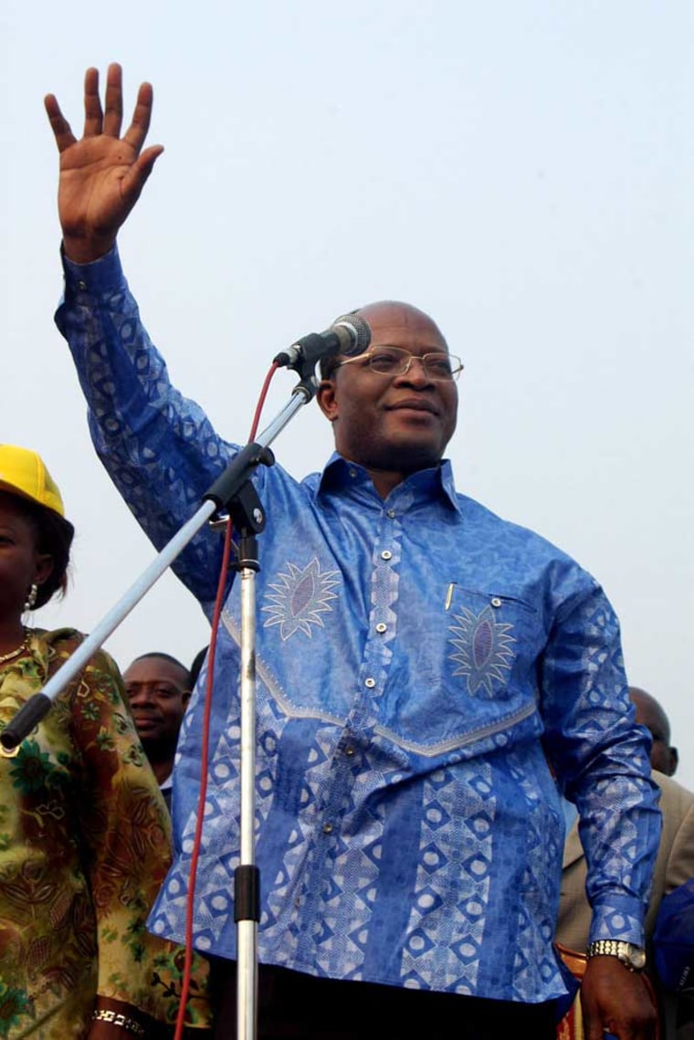 Congo presidential candidate Oscar Kashala waves to the crowd during a July campaign rally in Kinshasa, Congo. The Congolese-born doctor returned to his home country after nearly two decades in Boston to vie for the presidency against more than 30 other candidates in Congo's still undecided national elections. 