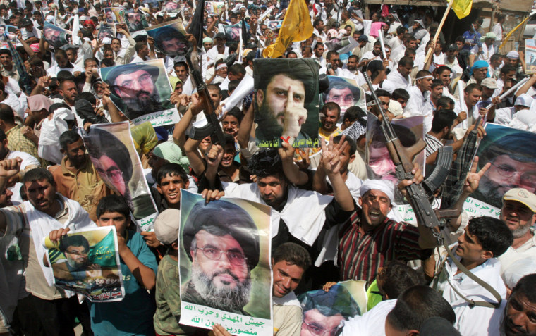 Portraits of Hezbollah leader Sheik Hassan Nasrallah and Iraqi Shiite cleric Muqtada al-Sadr are carried by Iraqi Shiites, as some thousands gather for a mass demonstration against Israel's bombing of Lebanon, Friday, Aug. 4, 2006, in the Sadr City area of Baghdad, Iraq. Over 200,000 Shiites filled the streets of the Shiite dominated Sadr City slum to attend a rally in support of Lebanon after Friday prayers. (AP Photo/Karim Kadim)