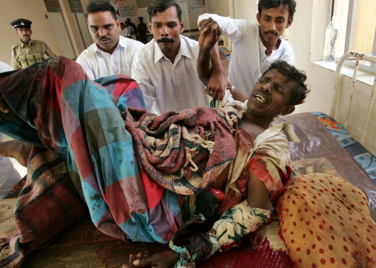 Medical staffers assist a wounded man after he was brought to a hospital in Trincomalee, Sri Lanka, on Friday.