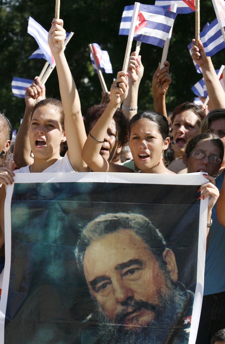 Girls in Havana hold a picture of Cuban leader Fidel Castro during a gathering on Sunday.
