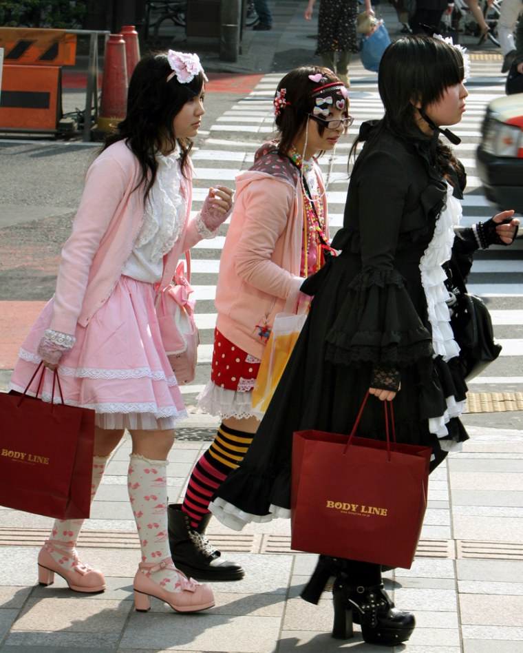 Japanese girls carry shopping bags at Omotesando in Tokyo