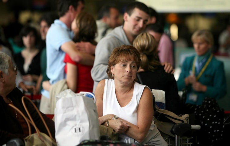 A stranded passenger waits for information on her flight at Dublin airport Thursday Aug. 10, 2006. Airlines across Europe canceled flights bound for London's Heathrow Airport Thursday while some airports said they were ready to take on diverted traffic after British authorities said they thwarted a terror attack aimed at aircraft flying from Britain to the U.S. (AP Photo/Niall Carson,PA) ** UNITED KINGDOM OUT NO SALES NO ARCHIVE **