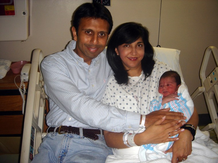 Rep. Bobby Jindal, left, his wife, Supriya, and their newborn son, Slade Ryan, sit in a hospital on Wednesday after Jindal helped deliver the couple’s third child.