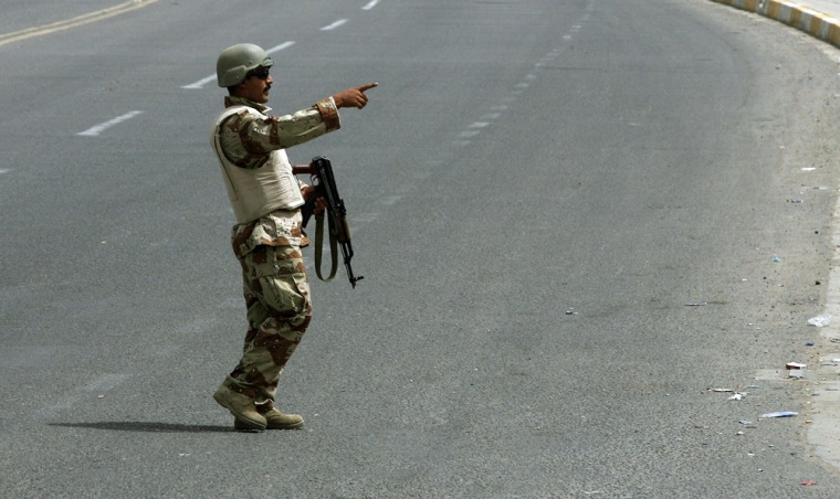An Iraqi policeman patrols a deserted street in Baghdad on Saturday at the start of a vehicle ban aimed at preventing violence during a major Shiite religious gathering. 