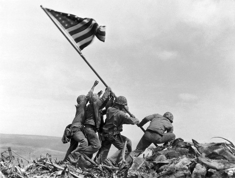** FILE ** In a file photo U.S. Marines of the 28th Regiment of the Fifth Division raise the American flag atop Mt. Suribachi, Iwo Jima, on Feb. 23, 1945. Joe Rosenthal, who won a Pulitzer Prize for his immortal image of six World War II servicemen raising an American flag over battle-scarred Iwo Jima, died Sunday. He was 94. (AP Photo/Joe Rosenthal)