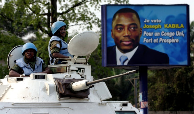 Ghanaian U.N. peacekeepers look out from the top of their armoured personnel carrier in Kinshasa