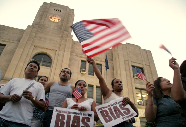 Hispanic protesters wave American flags outside of City Hall in Hazleton, Pa., Thursday, July 13, 2006. The City Council approved the Illegal Immigration Relief Act, which would would deny licenses to businesses that employ illegal immigrants, fine landlords $1,000 for each illegal immigrant discovered renting their properties, and require city documents to be in English only, at a meeting Thursday night. The 4-to-1 vote came after nearly two hours of passionate debate. (AP Photo/Rick Smith)