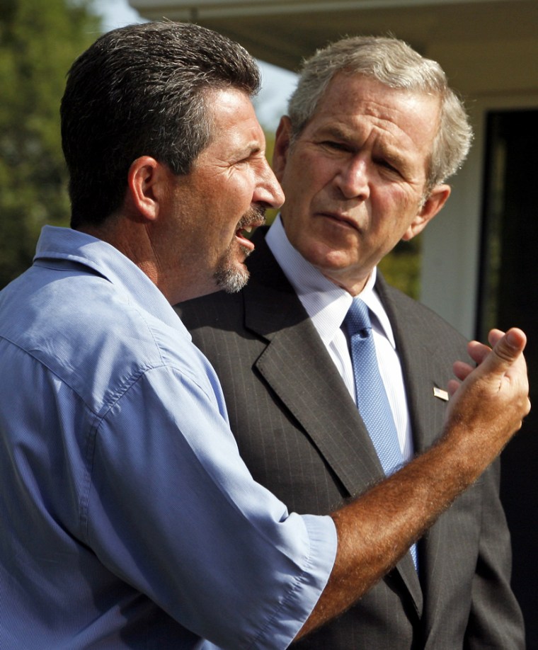 U.S. President George W. Bush listens to Hurricane Katrina survivor Rockey Vaccarella at the White House