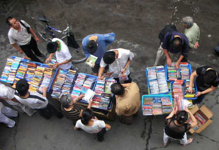 Local residents buy pirated DVDs on a street in Lanzhou, in China's Gansu province. U.S. officials say China's counterfeit exports cost legitimate producers worldwide up to $50 billion a year in lost potential sales.  