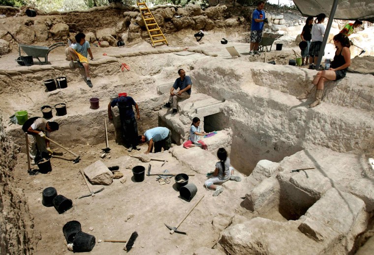 Israeli and international students and volunteers dig at an archaeological site near Jerusalem