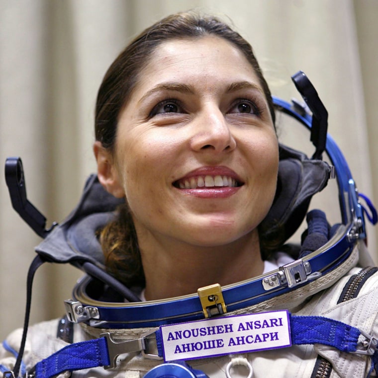 U.S. entrepeneur Anousheh Ansari smiles during an examination of the Soyuz space capsule in the Star City space centre outside Moscow