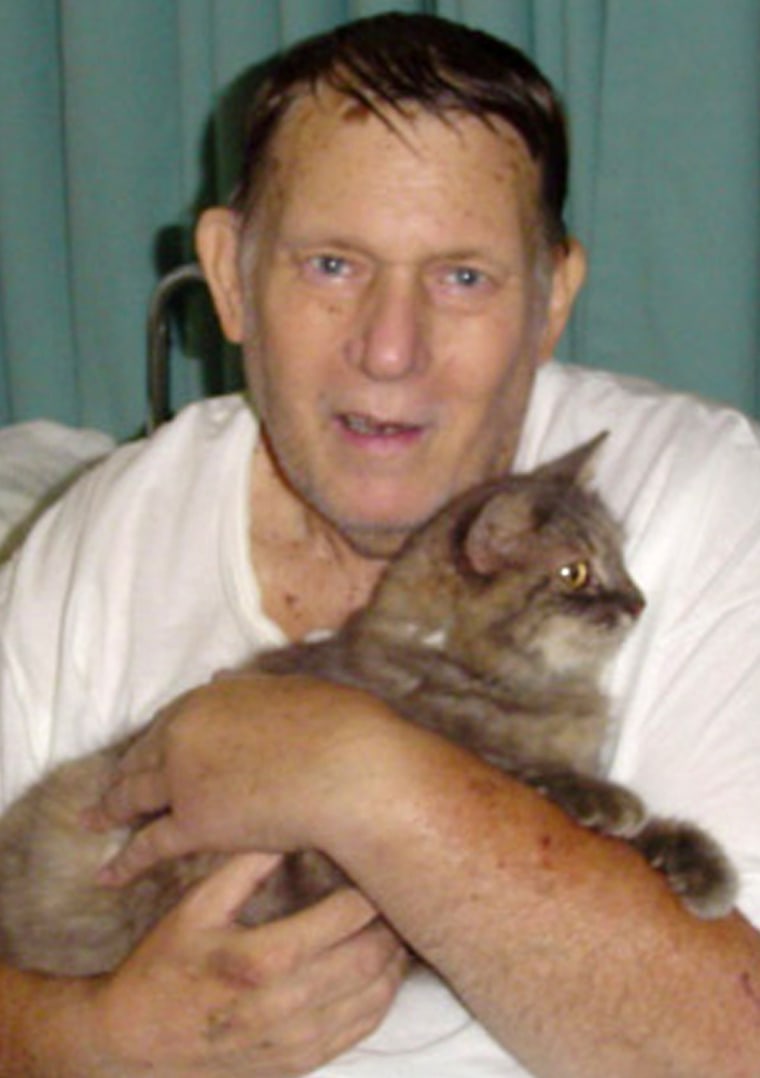 Bill Harris cradles Miss Kitty during their hospital reunion on Sept. 9, 2005.