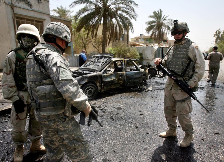 U.S. soldiers inspect the site of a car bomb explosion in Baghdad on Thursday. 