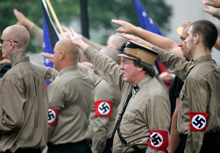 Members of the Minneapolis-based National Socialist Movement gesture during a Nazi rally on Saturday in Madison, Wis. 