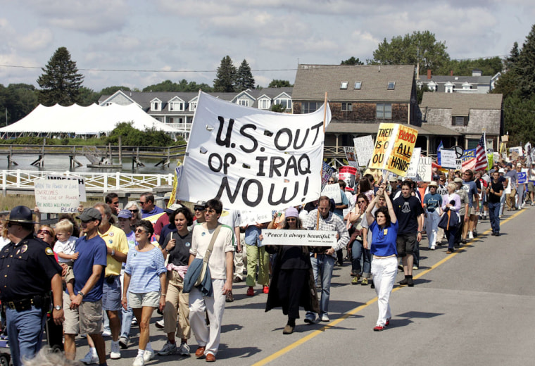 Anti-war protestors march down the street in Kennebunkport, Maine where US President George W. Bush is on vacation