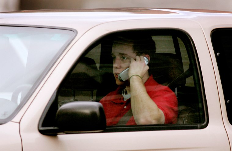 A motorist talks on a cell phone while driving. Palm CEO and co-founder Ed Colligan, interviewed by Forbes.com, supports a California bill that would require drivers to use headsets.