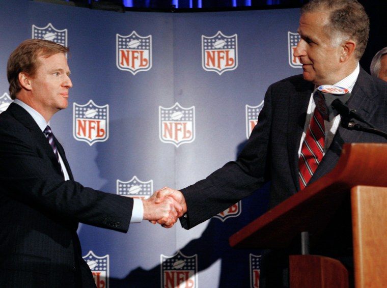 New NFL commissioner Goodell shakes hands with retiring commissioner Tagliabue after he was named the leagues new chief executive in Northbrook