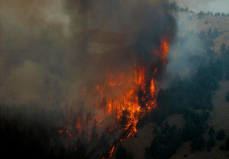 Flames race up a mountain in the Montana fire that jumped from 18,000 acres on Tuesday to 159,000 by Friday.
