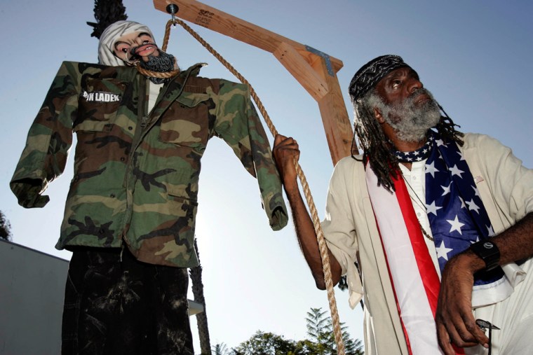 Ted Hayes, with the United American Committee, holds the rope to a noose that holds an Osama bin Laden effigy, across the street from the King Fahd Mosque in Los Angeles on Sunday.