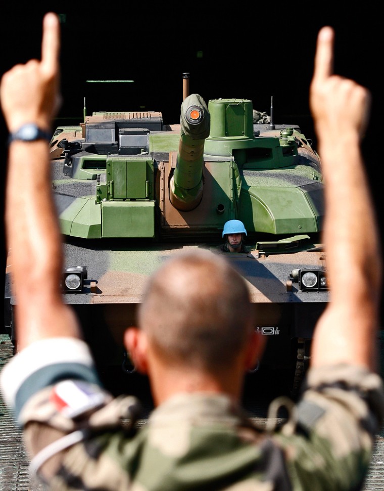 A U.N. French peacekeeper directs a colleague driving a Leclerc tank as it is unloaded in Beirut, Lebanon, on Tuesday.