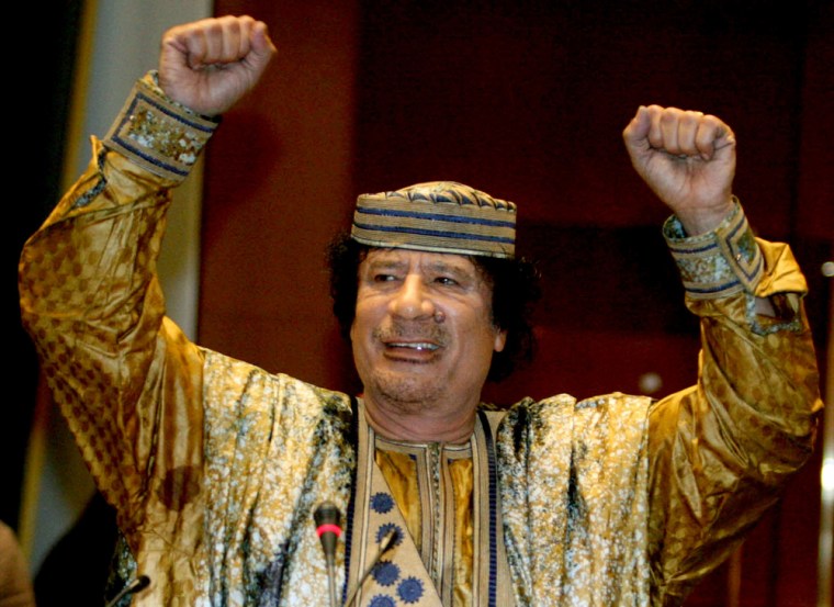 Libyan leader Muammar Gaddafi gestures as he addresses an Africa Union gathering in his hometown of Sirte