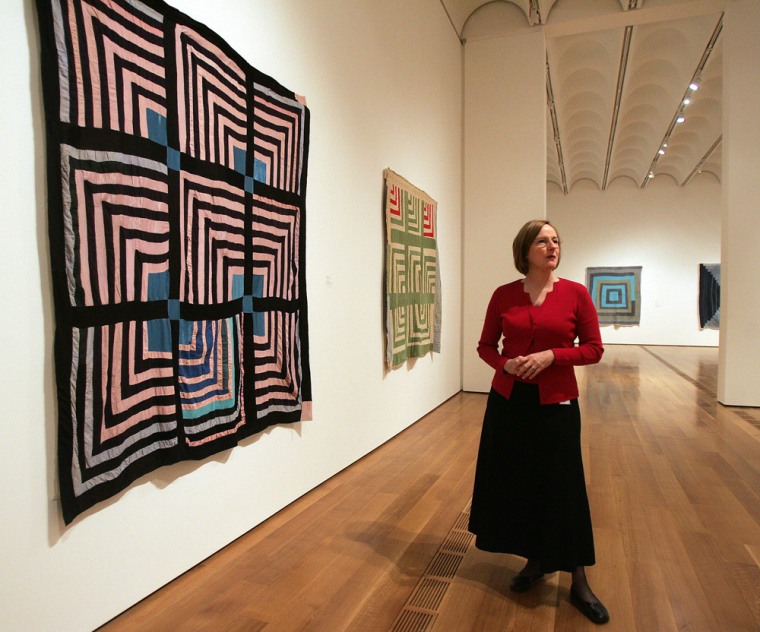 Susan Crawley, folk art curator at the High Museum of Art in Atlanta, speaks in front of a quilt by Sue Willie Seltzer at the museum's exhibition of \"The Quilts of Gee's Bend\" Wednesday, April 5, 2006. \"There is and has been an artistic tradition in this country of great significance of which we are unaware. It's born of necessity, but there is still an aesthetic decision to be made that marks genius,\" said Crawley. (AP Photo/John Bazemore)