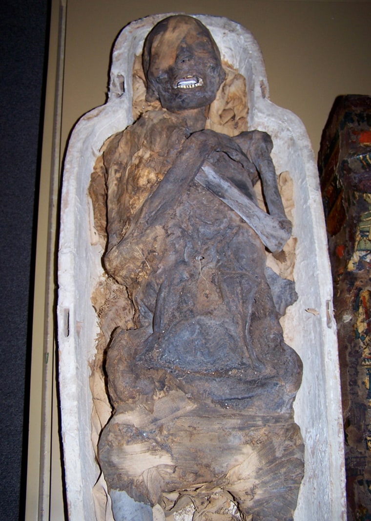 The mummy known as Pa-Ib has arms crossed on its chest. An opening on the left side, through which internal organs were extracted during the mummification process, can barely be seen.